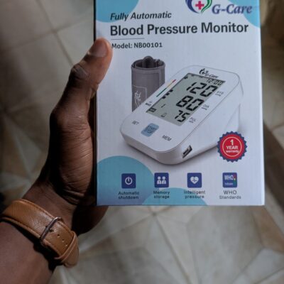 G-Care fully automatic upper-arm blood pressure monitor box showing digital display, cuff, and memory icons.